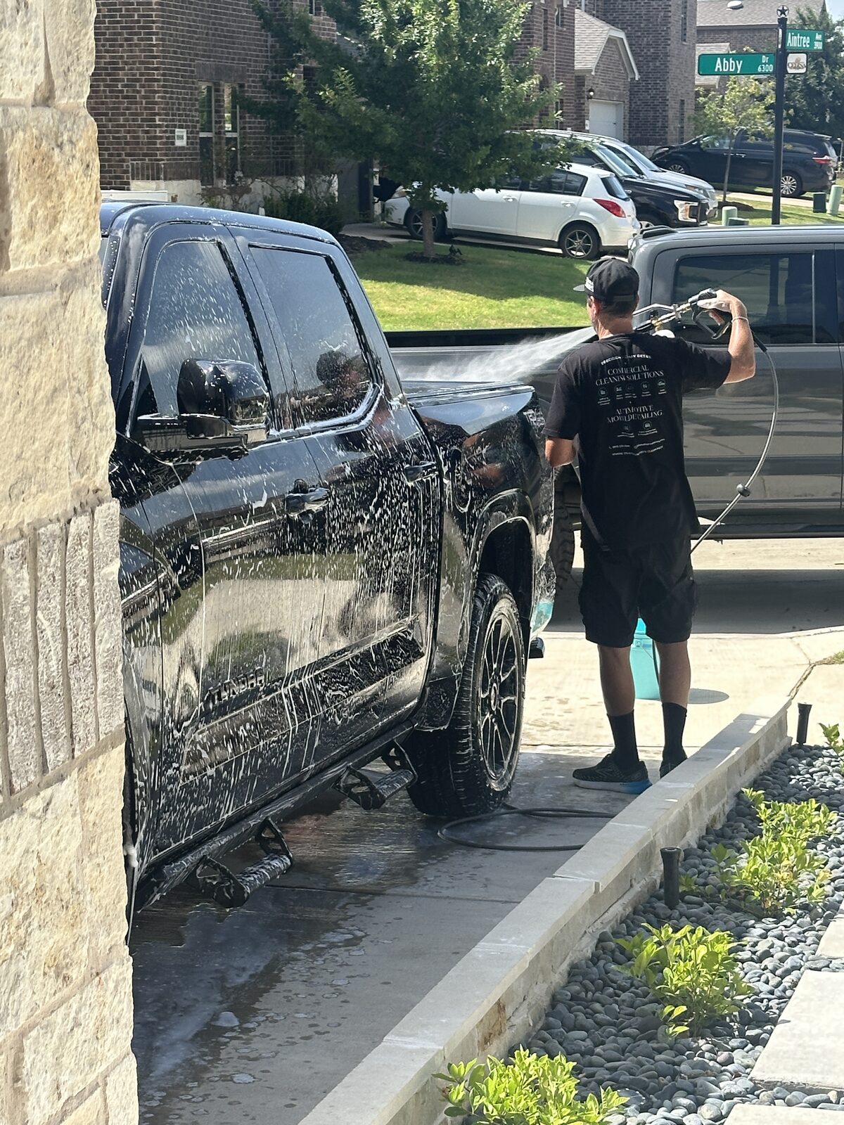 Mobile detailing crew washing a truck on site