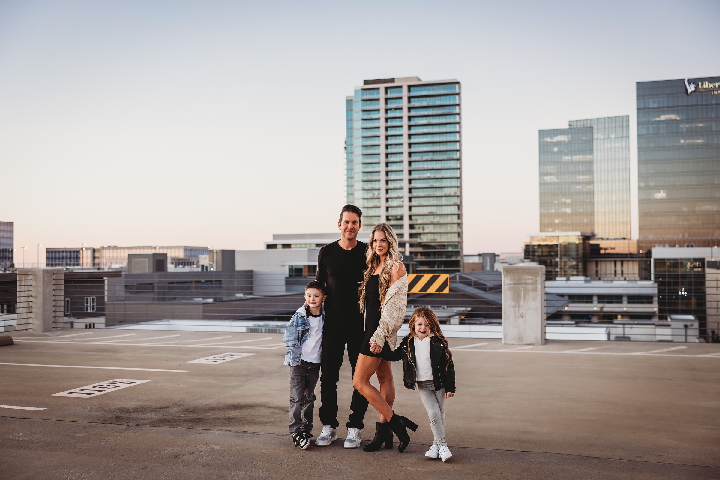 Mike Fitzpatrick, owner of Dialed In Pro Cleaning, with his family on a rooftop overlooking the Frisco skyline