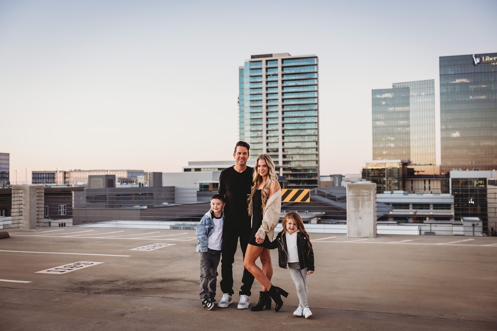 Mike Fitzpatrick, owner of Dialed In Pro Cleaning, with his family in front of the Dallas skyline